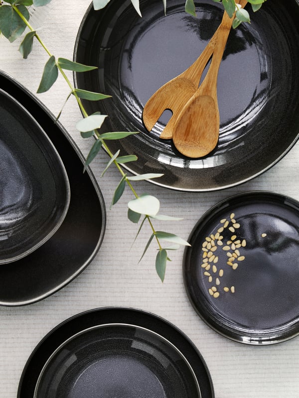 A dark grey GLADELIG serving bowl