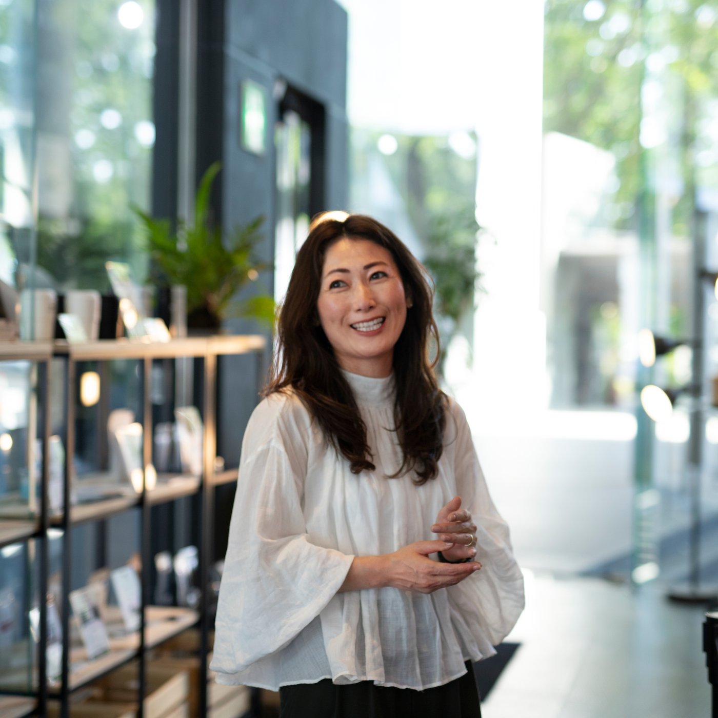 A business owner stands in her cafe smiling.