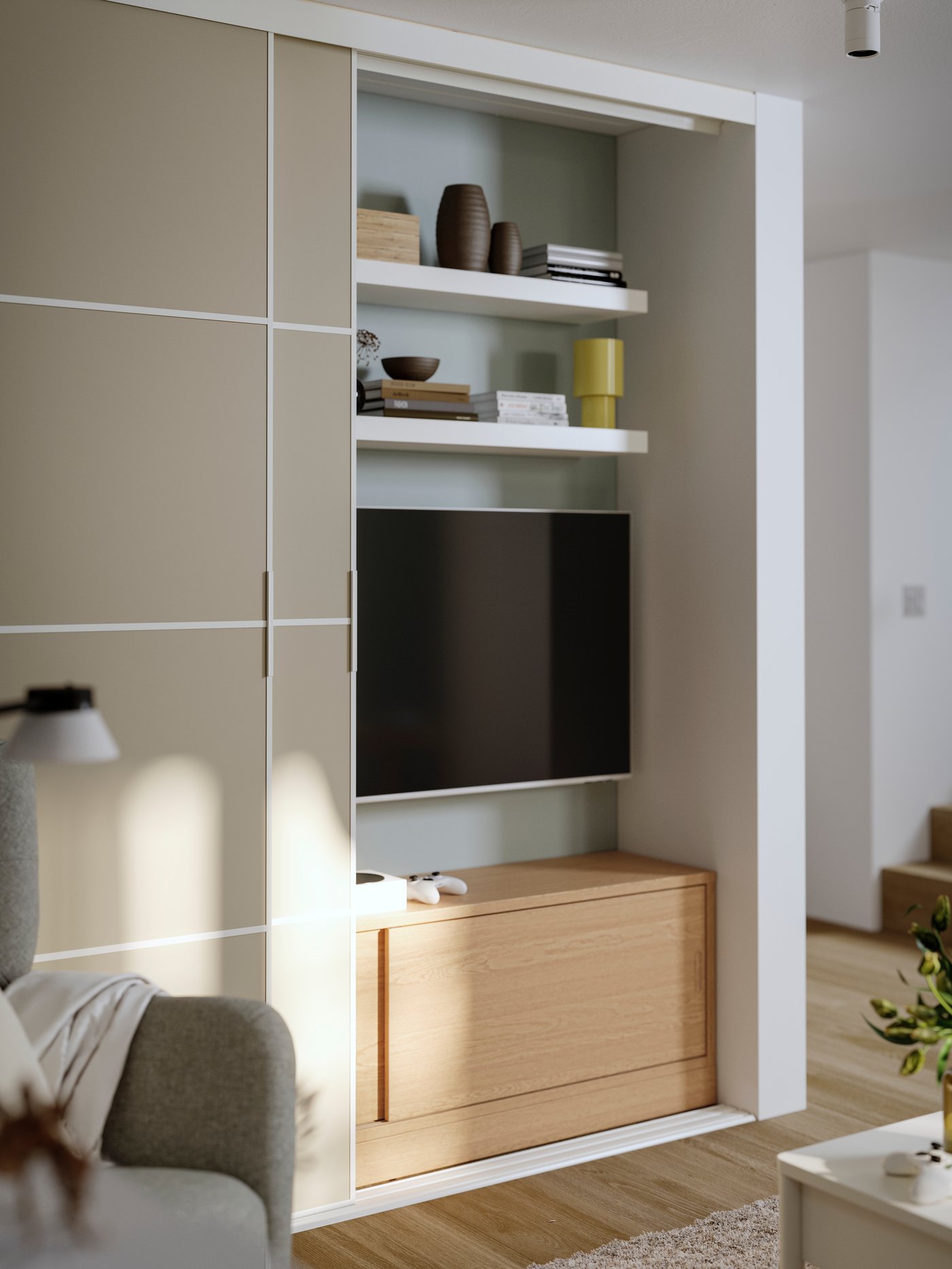 Two SKYTTA sliding doors in front of white shelves with books, deco objects, a TV screen and a wooden storage bench.