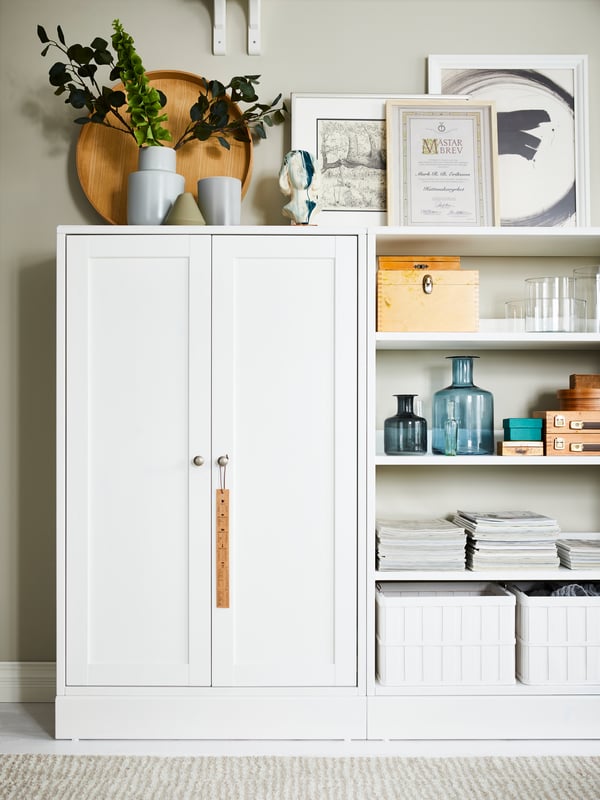 A HAVSTA storage combination with doors is placed alongside an open HAVSTA with a plinth.