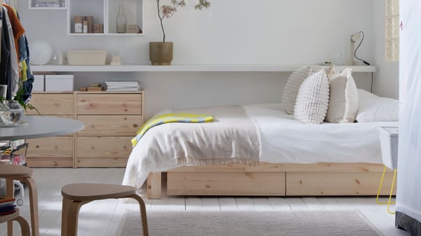 A bright bedroom with a GLAMBERGET extendable bed with storage, RAST chests of drawers, EKET cabinets, and more.