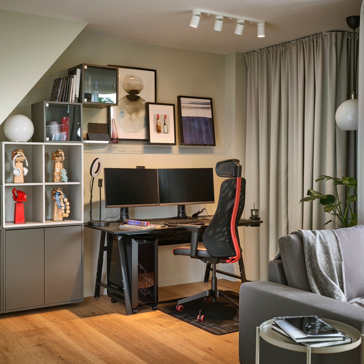 A dark grey EKET cabinet w 2 doors and 1 shelf in the home office