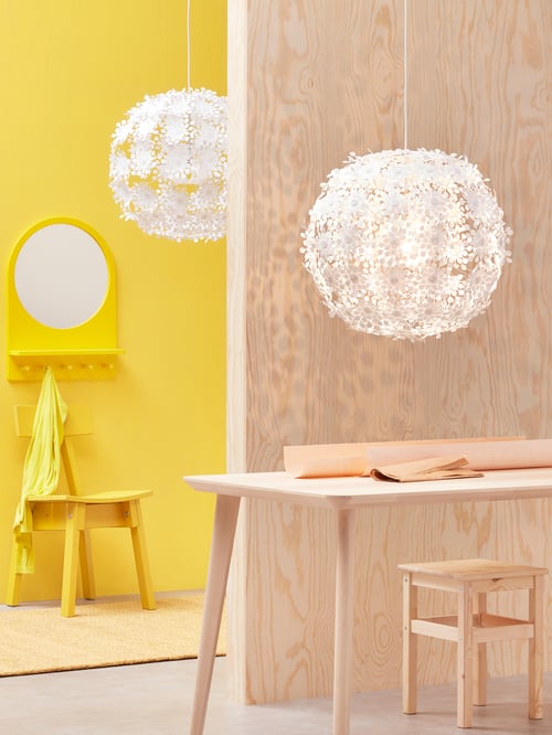 A hallway in the background with a workspace in the foreground, and each has a white GRIMSÅS pendant lamp hanging overhead.