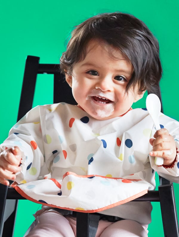 A black BLÅMES highchair with tray in the childrens room