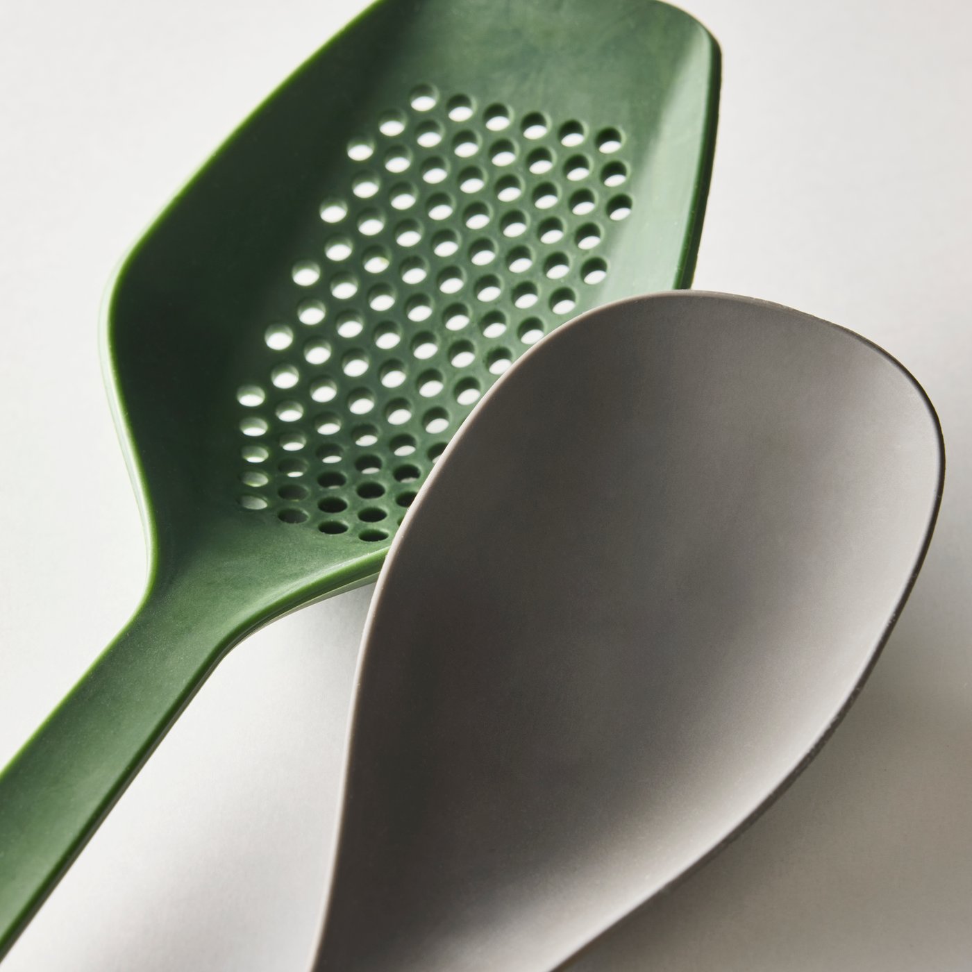 A KNORRHANE deep spoon for cooking and a multi utensil for cooking on a white surface.