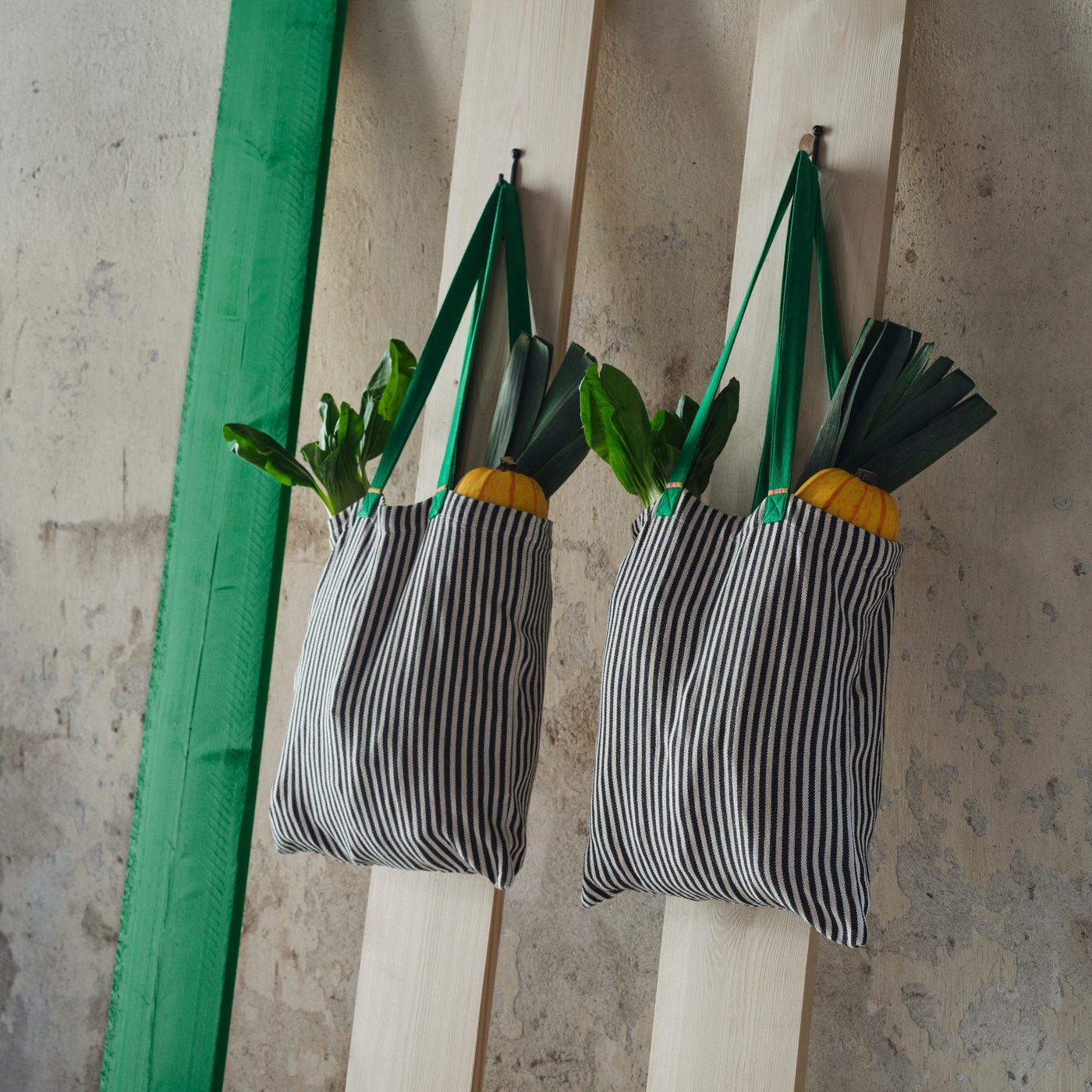 A green/stripe white/black MÄVINN bag