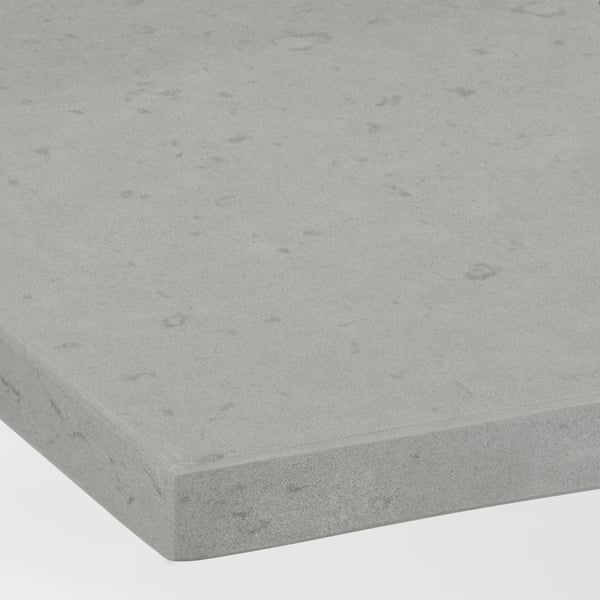 Close-up of a light gray countertop with a smooth matte finish and subtle marbled speckling.