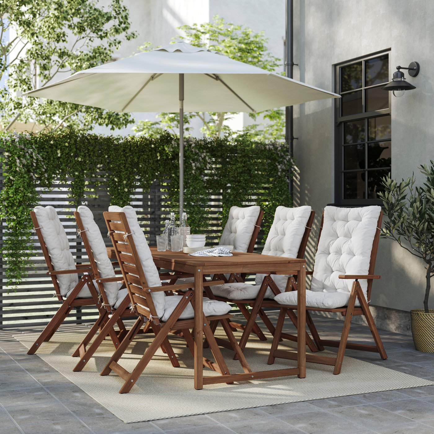 NÄMMARÖ sittegruppe med hvite stolputer plassert under en parasoll.