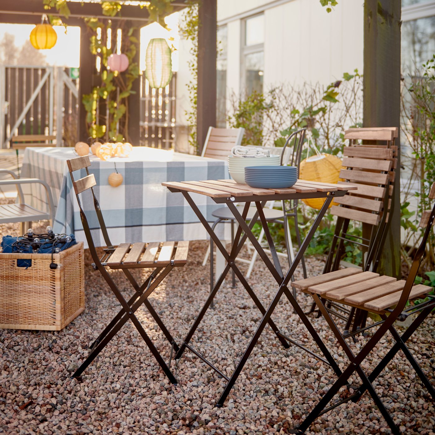 An outdoor space with a wooden TÄRNÖ garden table and wooden TÄRNÖ garden chairs.