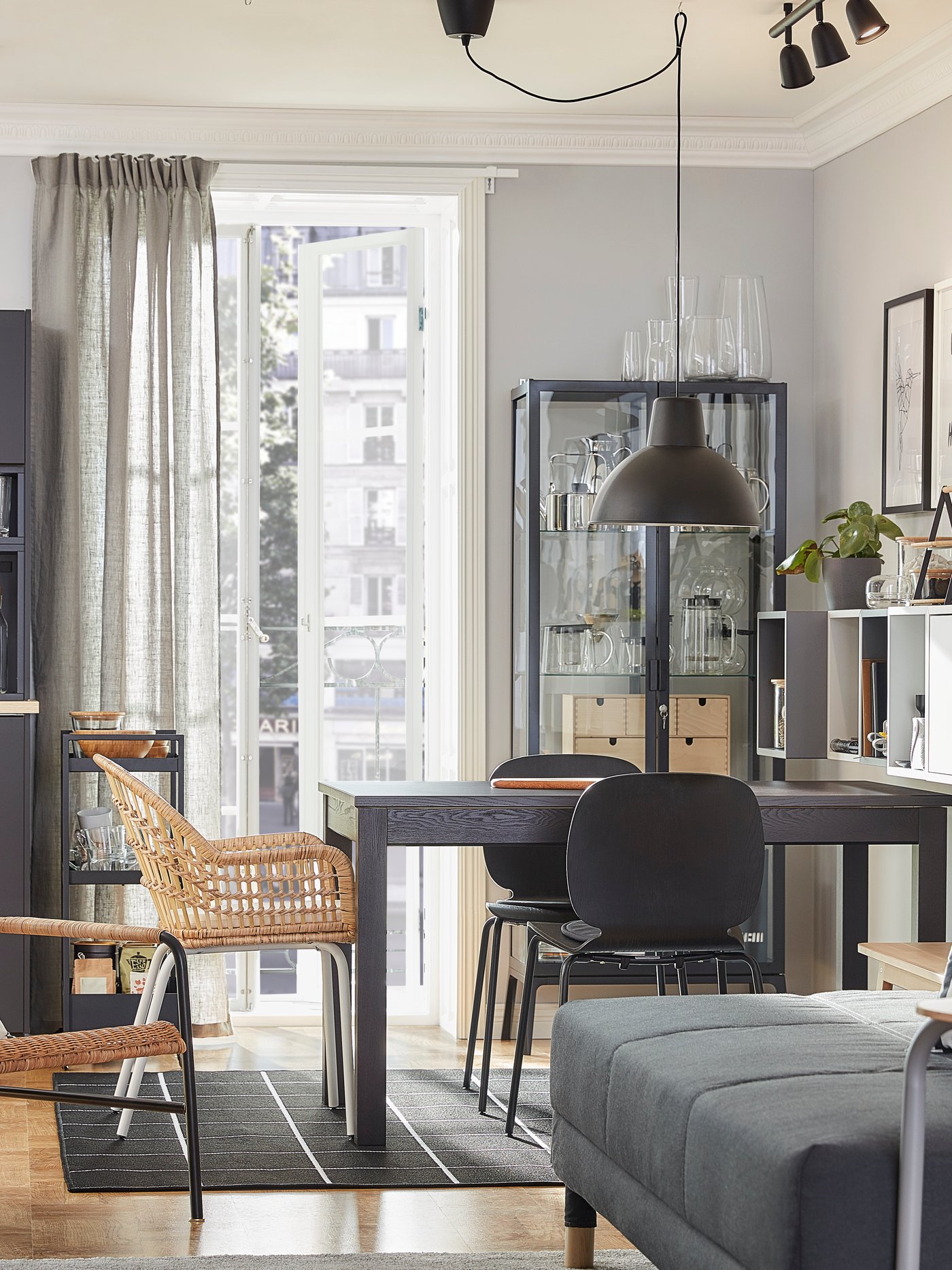 Vista de un departamento, en el fondo una mesa de comedor ractángular de la serie LANEBERG con una variedad de sillas.