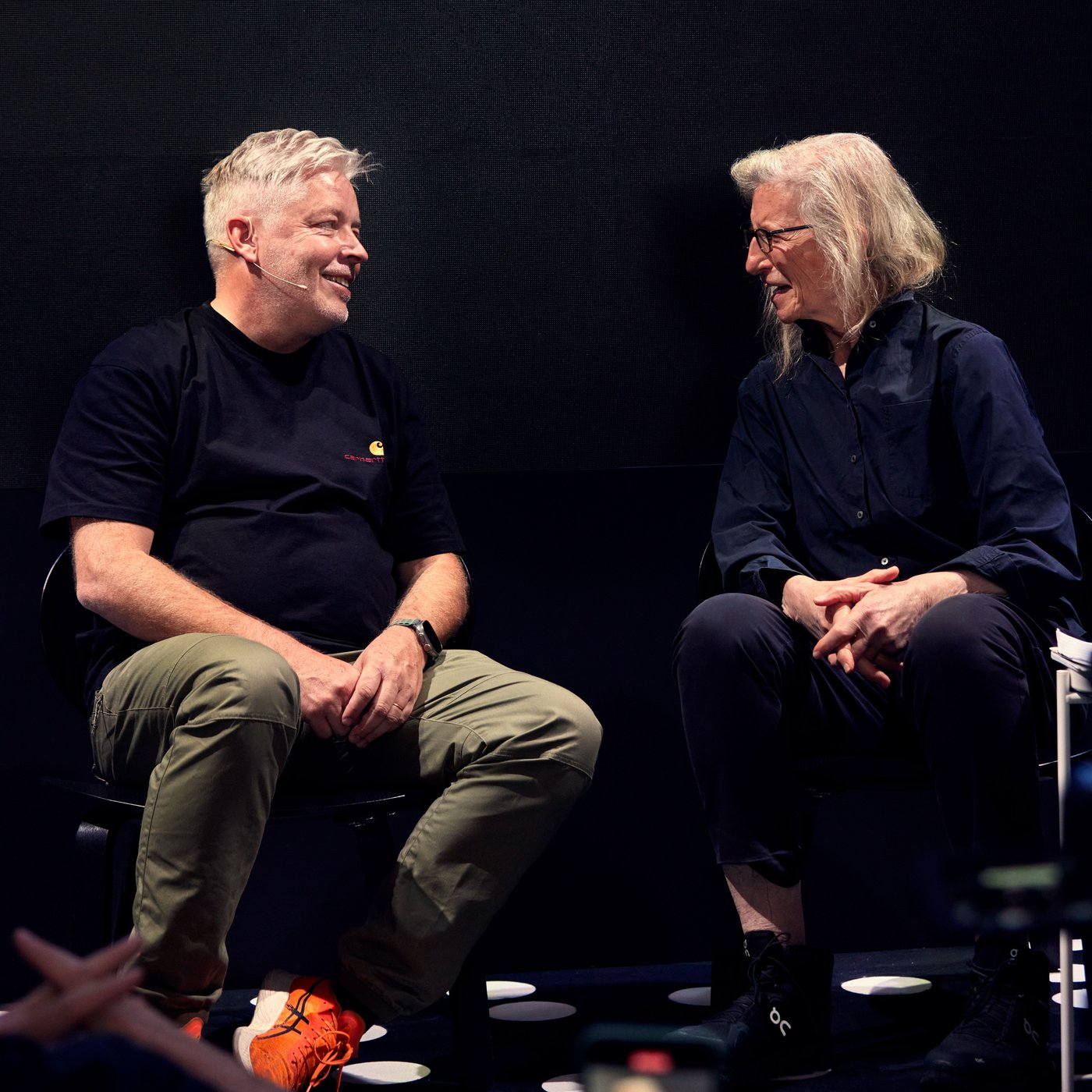 Two people at Milano fair having a discussion at the stage. 