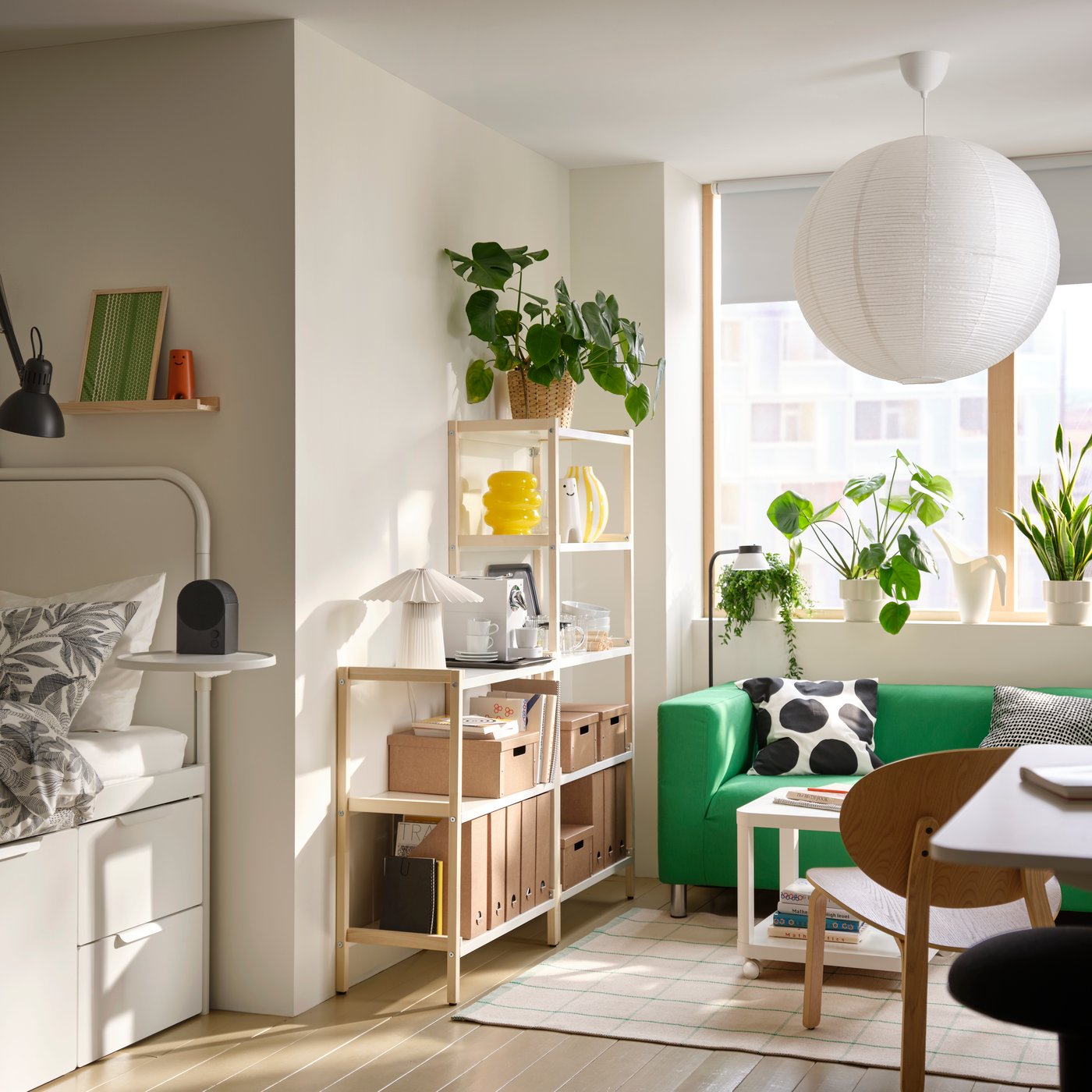 A tall EKENABBEN open shelving unit in aspen with white metal shelves is against a wall in a modern student room rental.