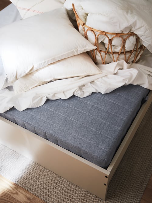 Baby and children room featuring a sprung mattress made of polyester, placed on a beige bed frame with headboard.