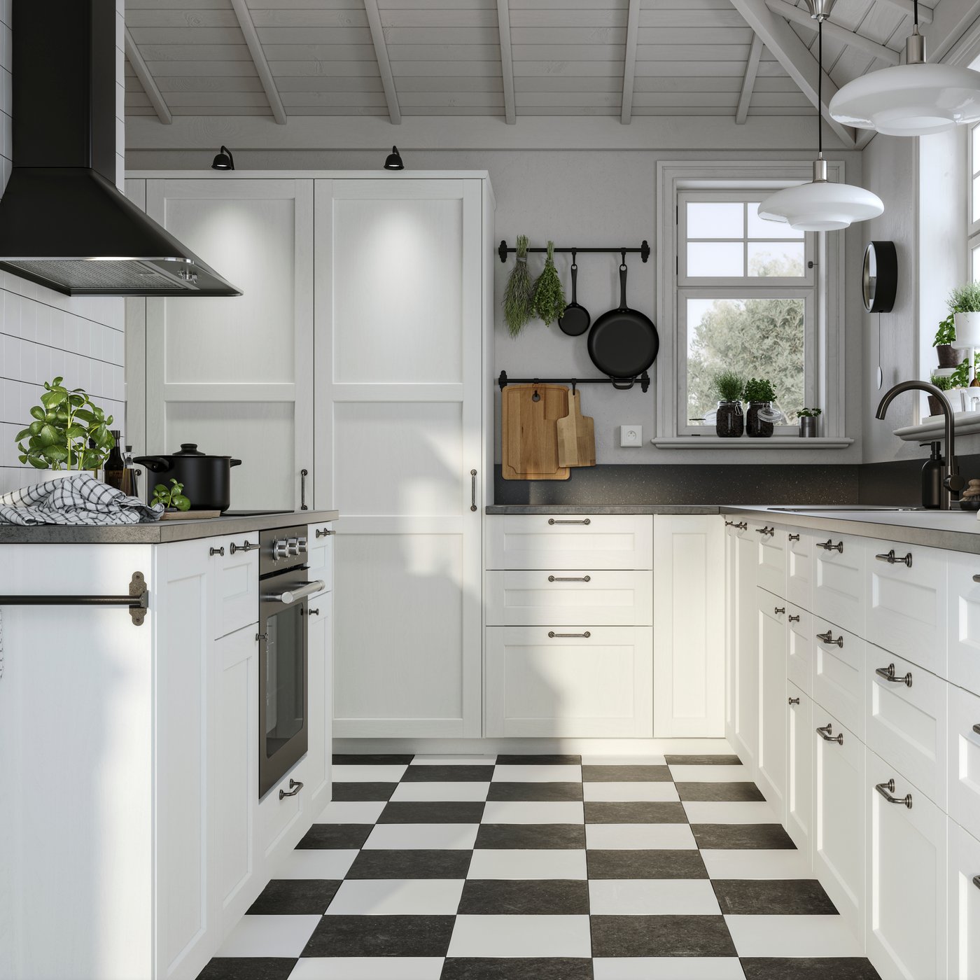 A black and white traditional-style kitchen with checkered black and white flooring, black handles and dark worktops