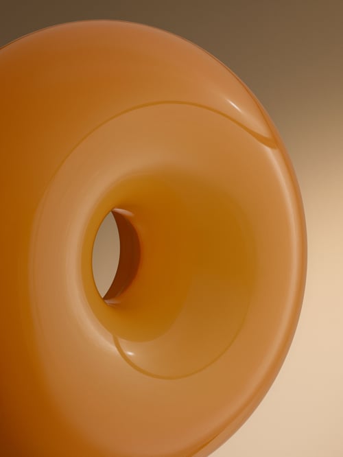 A close-up shot of an orange, donut-shaped VARMBLIXT LED wall lamp, mounted on a wall that is lit from the right side.