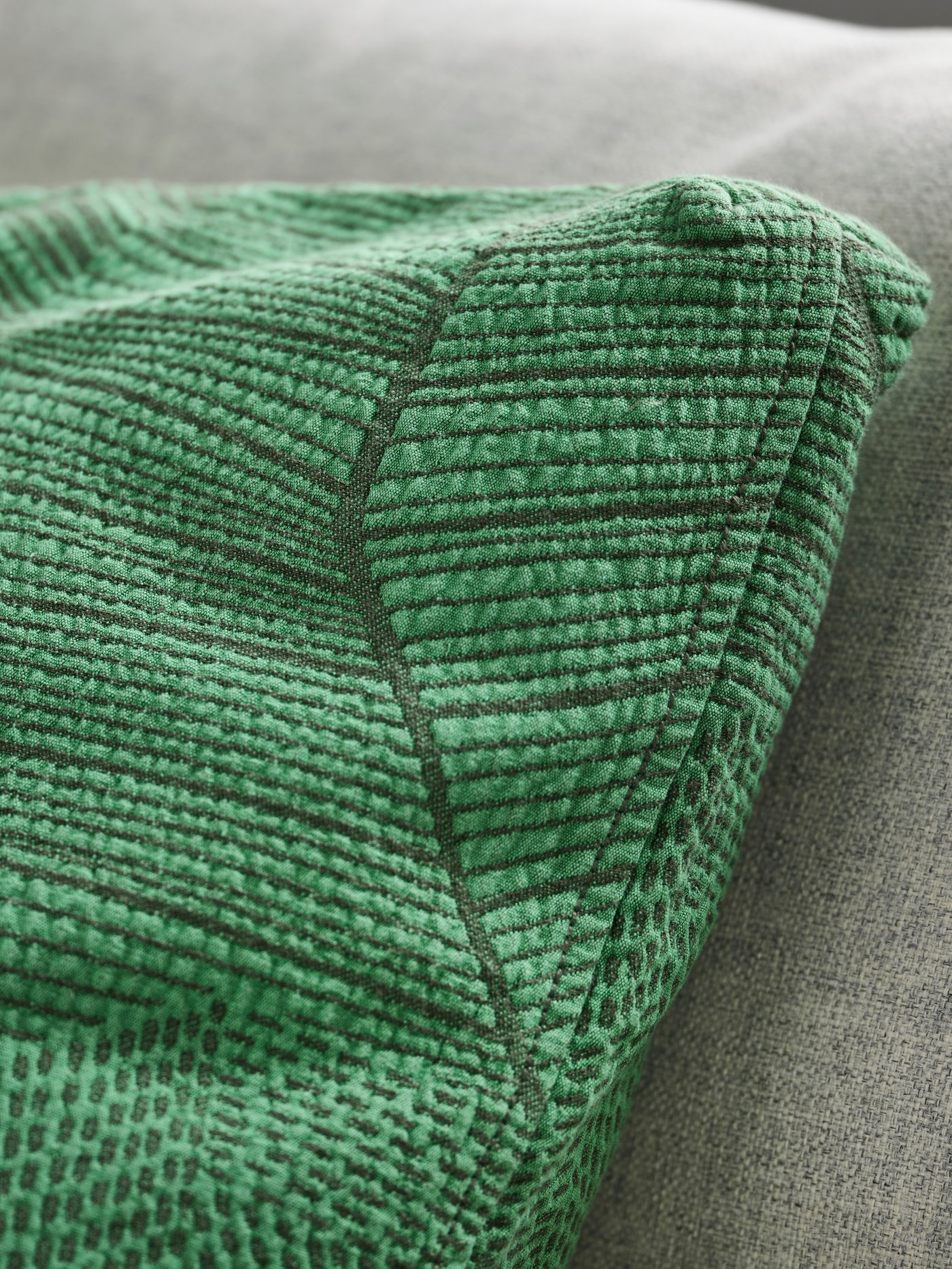 A green JÄTTEGRAN cushion cover