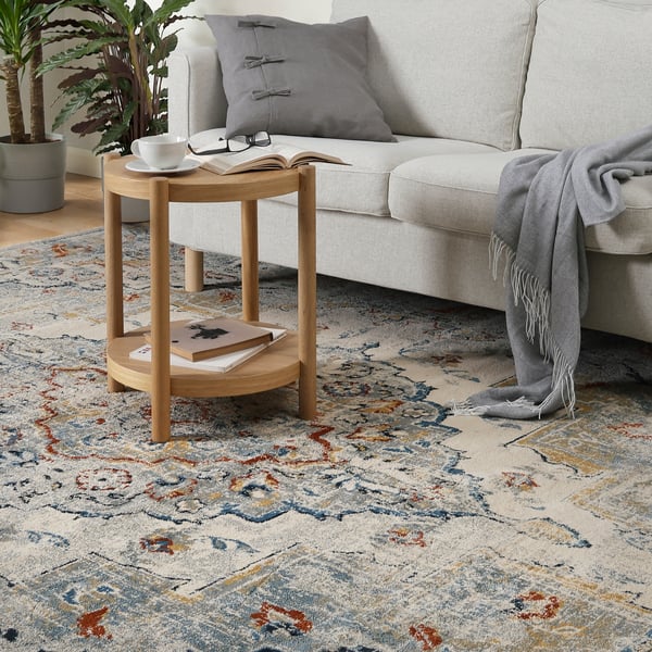 A close up shot of a living room scene with a multicolour ONSEVIG low pile rug.