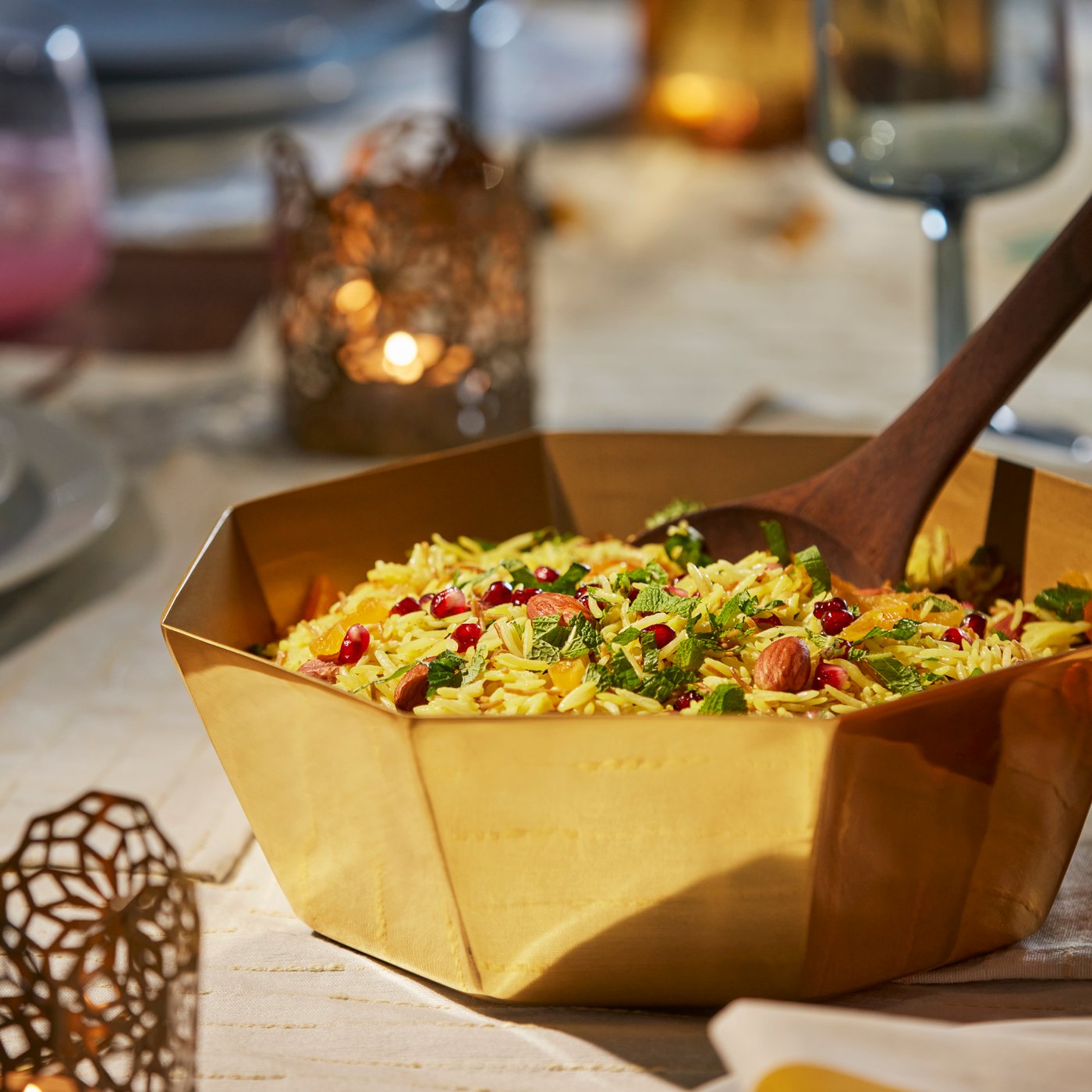 A gold-colour GOKVÄLLÅ serving bowl