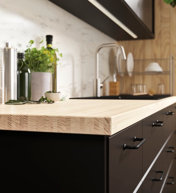 An ash/veneer PINNARP custom-made worktop in the kitchen