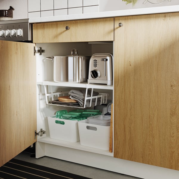 A KNOXHULT base cabinet with wooden doors and a drawer, neatly organised with kitchenware and appliances.
