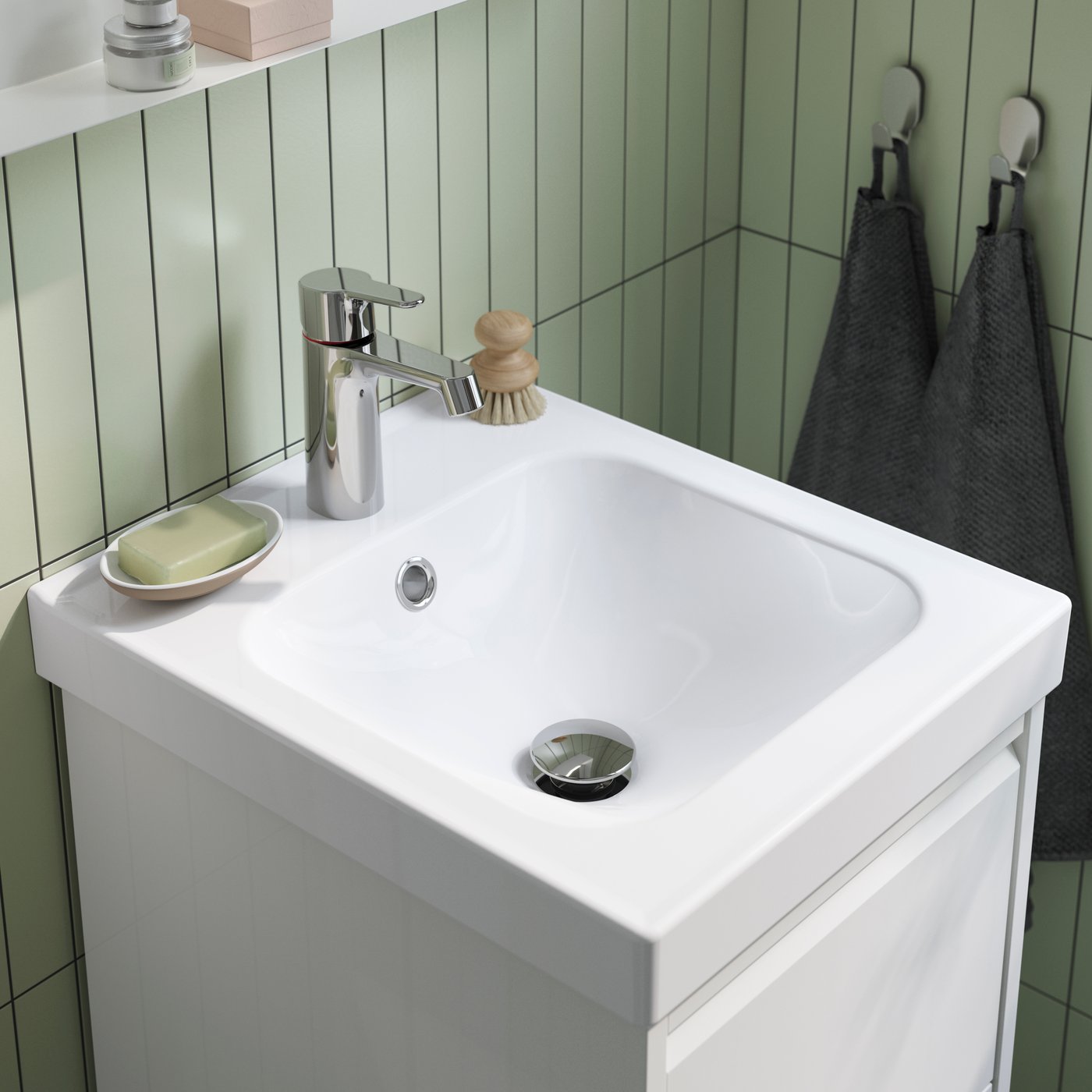 A white ORRSJÖN wash-basin with water trap in the bathroom