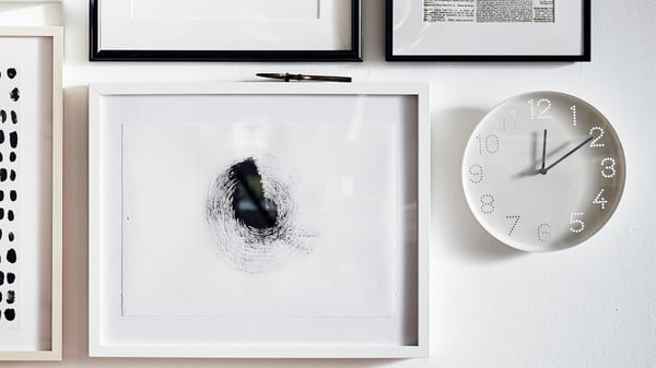 A white TROMMA wall clock