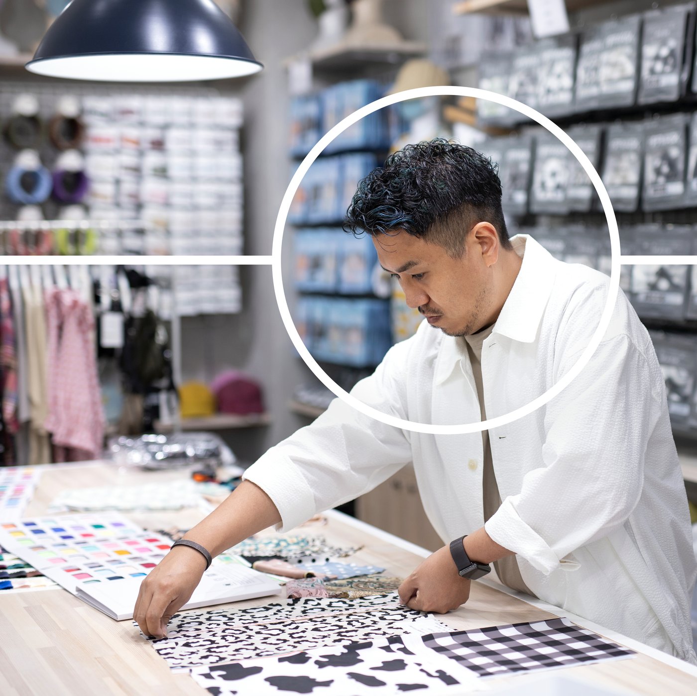 A person standing next to a working station with textiles.