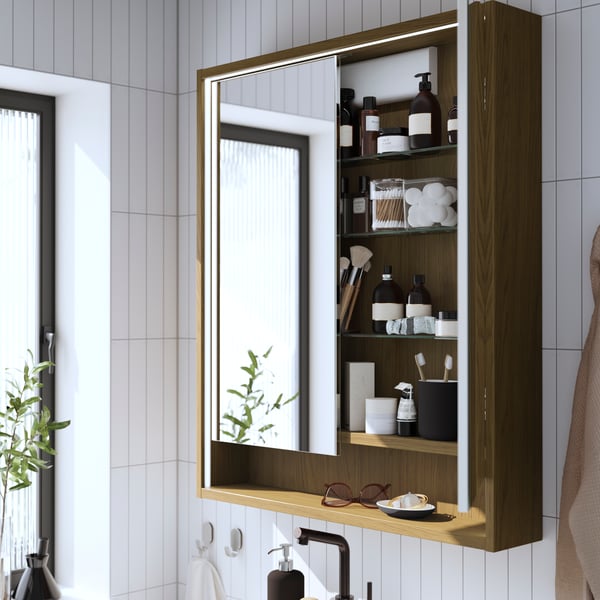 FAXÄLVEN mirror cabinet with a brown oak pattern and integrated lighting.