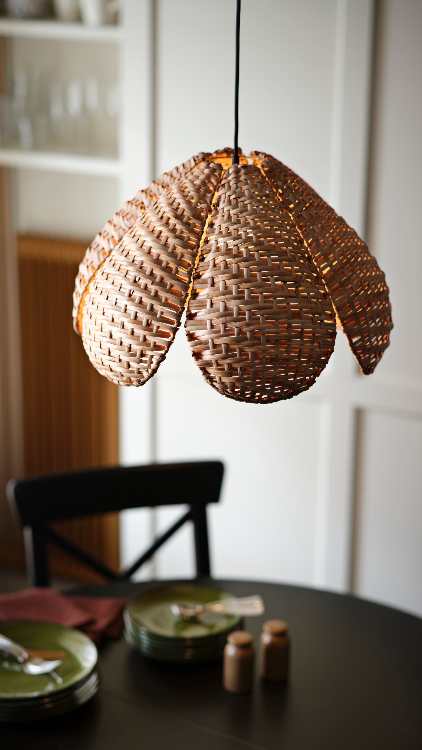 A handmade/rattan SANDKORN pendant lampshade in the dining room