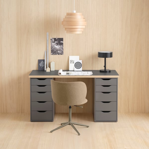 A dark grey/wood-effect LAGKAPTEN tabletop with two ALEX drawer units underneath, with a swivel chair in front.