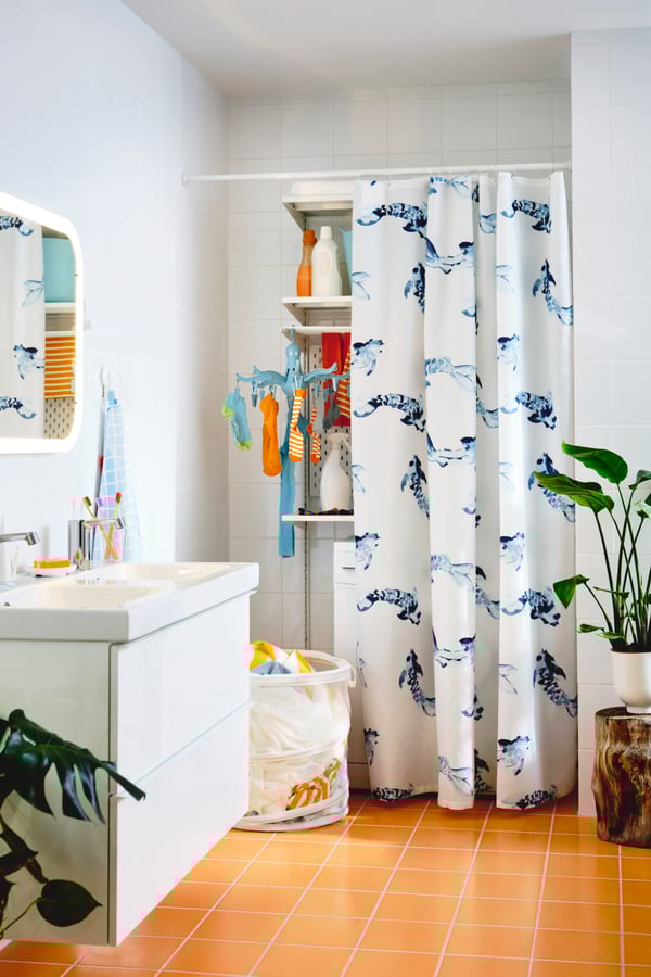 A white BOTAREN shower curtain rod in the bathroom