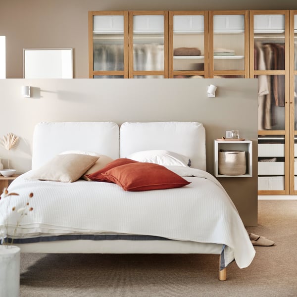 A Gräsbo white SAGESUND upholstered bed frame in the bedroom