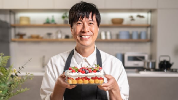 コウケンテツさんがプラントベースベビーカステラのスコップケーキを持っている