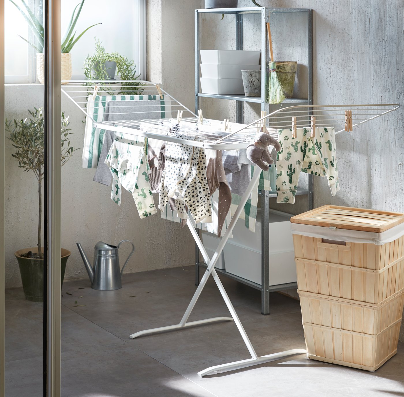 A white MULIG drying rack, in/outdoor in the laundry room