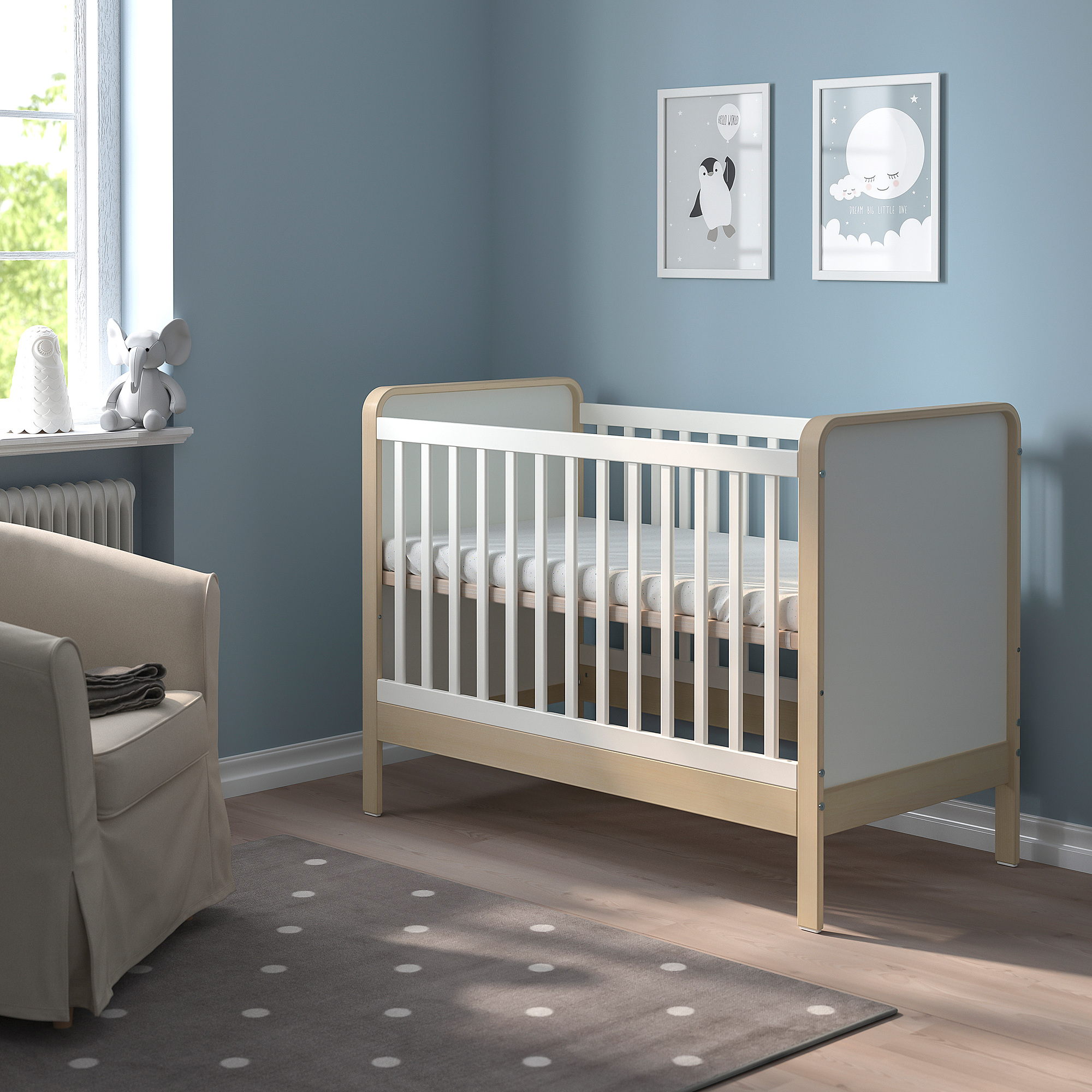 Beige cot against blue wall, grey rug, near armchair.