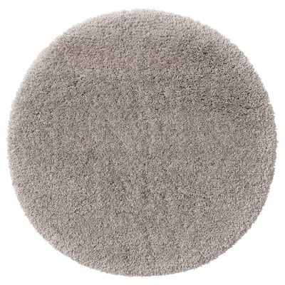 Round, gray, plush bath mat with soft microfiber texture, recycled polyester pile, and latex backing, ideal for comfort and absorption.