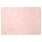 A light pink, rectangular bath mat named ALMTJÄRN. Its soft, made of microfiber with a latex backing for grip.