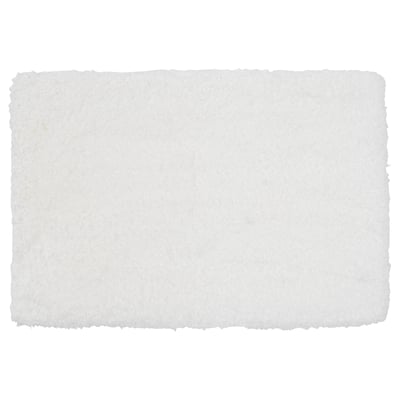 A white ALMTJÄRN bath mat, rectangular, with a soft microfibre top, and a latex backing for grip.