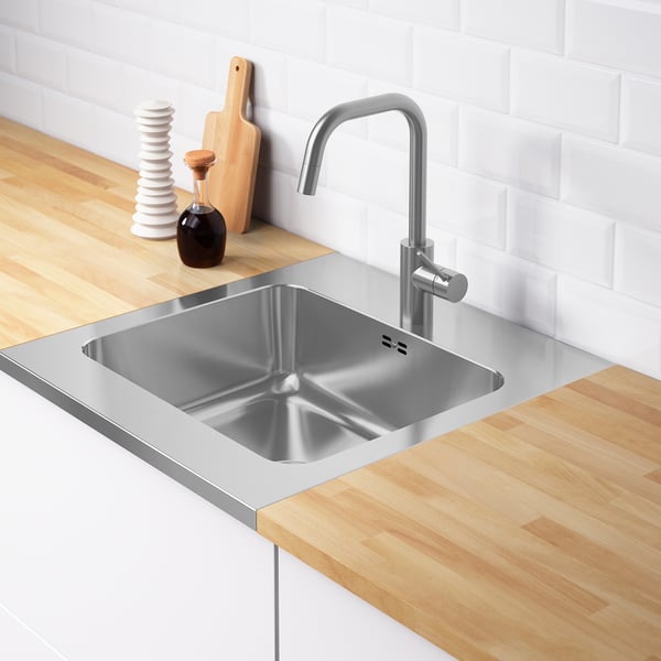 Stainless steel kitchen sink with a modern faucet set in a wooden countertop. The deep basin indicates effective space for washing.