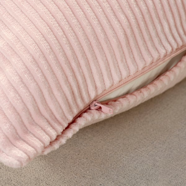 Light pink corduroy cushion cover with hidden zipper.