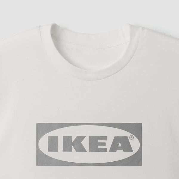 A high-quality white t-shirt from IKEA, featuring a prominent grey IKEA logo on the front. Its made of soft cotton, perfect for comfort.