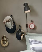 Bedside hooks: BÄNGBULA, black, steel, oval shape, wall mount. Red clock, lamp, striped pillow.