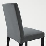 Modern gray upholstered dining chair with padded seat and back, sturdy black legs.