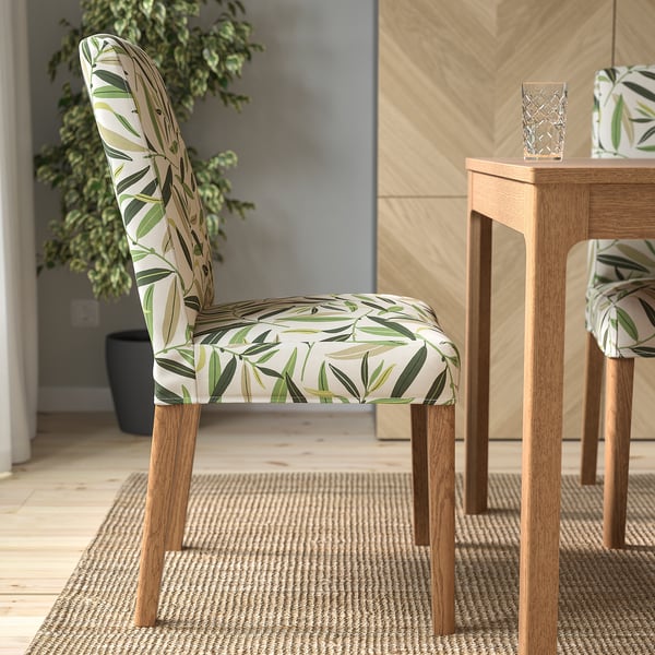 Upholstered chair with removable, washable floral cover, wooden legs, and comfortable seat padding. Perfect for dining.