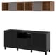 Option: A black BESTÅ tv storage unit and a wall-mounted shelf with wooden compartments and purple sections.