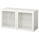 A white BESTÅ shelf unit with two glass doors and glass shelves.