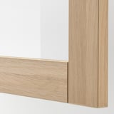 Close-up of light wood framed cabinet corner, showcasing smooth edge and high-quality finish.