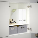 White BESTÅ cabinet with adjustable shelves and gray fabric storage boxes.