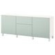 Modern white and light green BESTÅ sideboard with rectangular design and multiple compartments. Sturdy, sleek and minimalist look, sits on four legs.