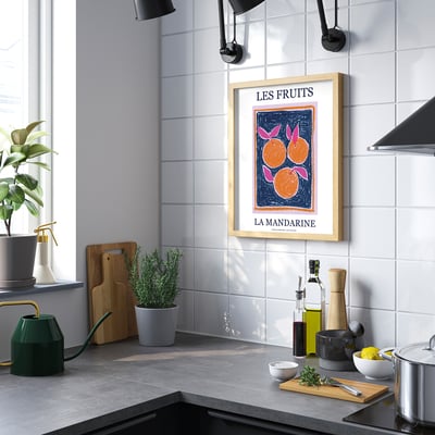 Modern kitchen with orange poster above counter.